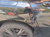 a reflection of a man on the side of a car