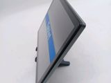 a tablet computer sitting on a stand on a table