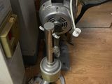 a machine that is sitting on the floor next to a refrigerator