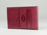a red leather wallet with a card holder on top of it
