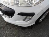 a close up of a white car parked on the street
