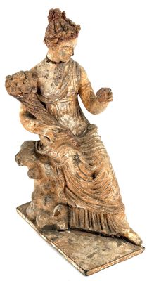 statue of a woman sitting on a rock with a dog