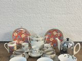 une photo représentant un ensemble de tasses et de soucoupes à thé et à café posées sur une table