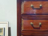 an image of a wooden dresser with a marble top