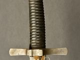 a close up of a sword with a metal handle