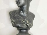 statue of a bust of a man with a red marble base