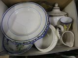a box full of dishes and cups that are sitting in it