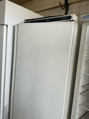 two white refrigerators in a kitchen next to each other