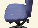 a blue office chair that has a hole in the back of it
