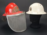 pair of firemen ' s hard hats with mesh face shields