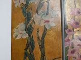 two paintings of flowers painted on the wall next to each other