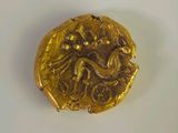 gros plan d'une pièce d'or sur une surface blanche