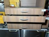 a drawer with three drawers in it in a room