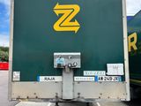 a large green truck with a yellow z logo on the back