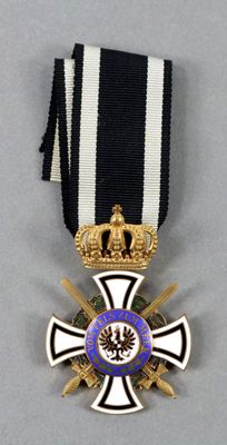 a close up of a medal with a cross on it