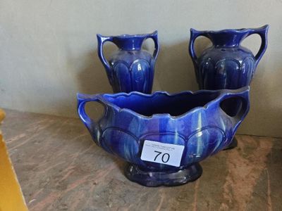 deux vases bleus posés sur une table, avec une étiquette de prix
