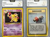 two pokemon cards with different designs on them on a table