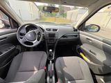 the interior of a small car with a steering wheel and dashboard