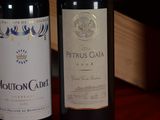 two bottles of wine sitting next to each other on a table