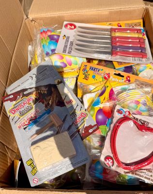 a cardboard box filled with toys and other items