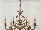 an antique brass chandelier with five lights hanging from the ceiling