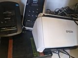 a printer sitting on top of a shelf next to a printer