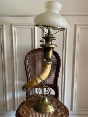 a lamp that is on top of a wicker chair