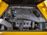 a small engine in the back of a yellow car