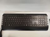 a black keyboard and mouse on a white table