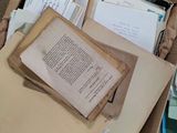 a box full of papers and papers sitting on the floor