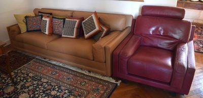 a couch and chair in a living room with a rug