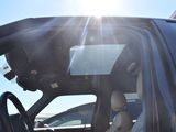 a black car with the sun shining through the window