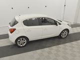 a picture of a small white car parked in a garage