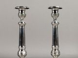 pair of silver candlesticks on a silver background