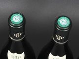 bottles of wine are lined up in a row on a table