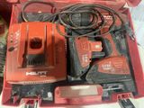 a red box with tools in it sitting on a table