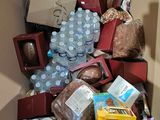 a cardboard box full of food and drinks in it