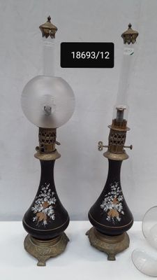 pair of black and gold vases with a clear glass on top
