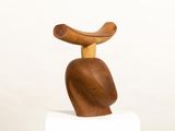 a wooden sculpture of a bird sitting on top of a block