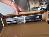 a person opening a box with a keyboard inside of it