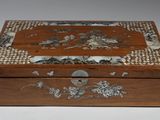 an old wooden box with a design on the inside of it