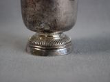 a silver cup that is sitting on a table