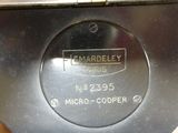 a close up of a metal object with a name on it