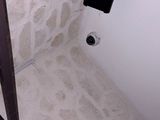 a bathroom with a toilet and a shower in it