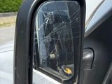 a car mirror with a broken glass on the side of it