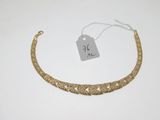 a gold bracelet with a tag on it