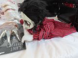 a doll that is laying on a bed next to a book