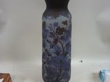 a blue vase sitting on a table next to other items