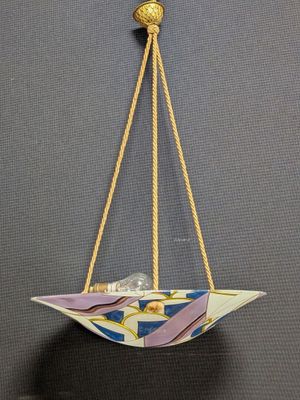 a close up of a paper boat hanging from a rope