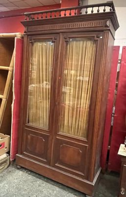 a large wooden cabinet in the middle of a room